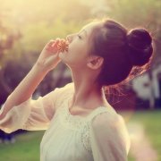 女生嘴中叼花的意境丸子头头像图片